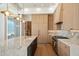 Well-appointed kitchen with custom cabinets, marble counters, and modern appliances at 6202 E Larkspur Dr, Scottsdale, AZ 85254