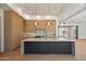 Bright kitchen with wood cabinets, marble countertops, and a large island with pendant lighting at 6202 E Larkspur Dr, Scottsdale, AZ 85254