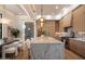 Bright kitchen featuring a large island with seating, custom wine rack, and high-end appliances at 6202 E Larkspur Dr, Scottsdale, AZ 85254