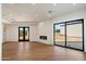 Open-concept living room with a modern fireplace and large sliding doors to the backyard at 6202 E Larkspur Dr, Scottsdale, AZ 85254