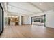 Open-concept living room with wood floors and sliding doors to outdoor living space and kitchen views at 6202 E Larkspur Dr, Scottsdale, AZ 85254