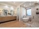 Bright main bathroom with double vanity, soaking tub, glass shower, and stylish fixtures at 6202 E Larkspur Dr, Scottsdale, AZ 85254