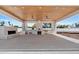 Expansive outdoor kitchen with wood ceiling, stone pizza oven and built in grill at 6202 E Larkspur Dr, Scottsdale, AZ 85254