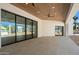 Expansive patio with stone floors and multi-slide doors leading to the backyard at 6202 E Larkspur Dr, Scottsdale, AZ 85254