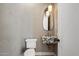 Elegant powder room with marble sink, unique lighting, and stylish fixtures at 6202 E Larkspur Dr, Scottsdale, AZ 85254