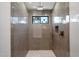 Modern shower featuring neutral tile, geometric floor tiles, and a rain shower head at 6202 E Larkspur Dr, Scottsdale, AZ 85254