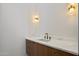 Bathroom vanity featuring a white countertop, wood cabinetry, and unique sconce lighting at 6202 E Larkspur Dr, Scottsdale, AZ 85254