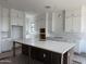 Spacious kitchen with white cabinets, an island with quartz countertop and a sink at 778 W Seagull Dr, Queen Creek, AZ 85140