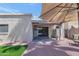 Inviting backyard patio with a covered area, sliding glass door, and a manicured lawn at 7917 E Cactus Wren Rd, Scottsdale, AZ 85250