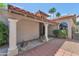 Inviting front entrance with stately columns, a red brick walkway, and well-manicured landscaping at 7917 E Cactus Wren Rd, Scottsdale, AZ 85250