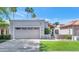 Charming home featuring a two-car garage, desert landscaping, and a clay tile roof under a sunny sky at 7917 E Cactus Wren Rd, Scottsdale, AZ 85250