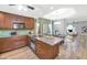 Modern kitchen features wooden cabinets, light countertops, stainless steel appliances and open access to the dining area at 7917 E Cactus Wren Rd, Scottsdale, AZ 85250