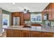 Spacious kitchen with wood cabinets, stainless steel appliances, and a large island, perfect for cooking at 7917 E Cactus Wren Rd, Scottsdale, AZ 85250