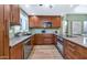 Modern kitchen with sleek countertops, wood cabinets, and stainless steel appliances, offering functionality at 7917 E Cactus Wren Rd, Scottsdale, AZ 85250