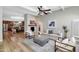 Bright living room featuring wood floors, a fireplace, a ceiling fan, and stylish, modern furnishings at 7917 E Cactus Wren Rd, Scottsdale, AZ 85250