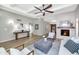 Open-concept living room featuring wood floors, a fireplace, and views into the kitchen at 7917 E Cactus Wren Rd, Scottsdale, AZ 85250