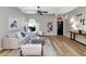 Bright living room boasts wood floors, a ceiling fan, and multiple windows to let in natural light at 7917 E Cactus Wren Rd, Scottsdale, AZ 85250