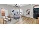 Well-lit living room showcasing wood floors, neutral furniture, arched windows, and a contrasting black door at 7917 E Cactus Wren Rd, Scottsdale, AZ 85250