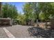 Landscaped backyard featuring gravel ground cover and shade trees, perfect for creating a serene outdoor space at 865 E Rojo Ct, Gilbert, AZ 85297