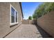 Side yard featuring neutral gravel ground cover, offering a clean and low-maintenance outdoor area at 865 E Rojo Ct, Gilbert, AZ 85297