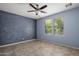 Neutral toned bedroom featuring tile flooring, a ceiling fan, and natural light from two windows at 865 E Rojo Ct, Gilbert, AZ 85297