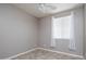 Clean bedroom with ceiling fan and lots of natural light at 865 E Rojo Ct, Gilbert, AZ 85297