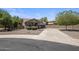 Charming single-story home with neutral tones, lush landscaping, and a winding driveway to the garage at 865 E Rojo Ct, Gilbert, AZ 85297