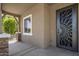 Inviting covered porch with decorative security screen door and neutral colored walls at 865 E Rojo Ct, Gilbert, AZ 85297