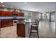 Open kitchen with bar stool seating, dark wood cabinets and stainless steel appliances that lead to a living area at 865 E Rojo Ct, Gilbert, AZ 85297