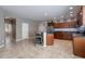 Bright kitchen featuring stainless steel appliances, dark cabinets, tile flooring, and barstool seating at 865 E Rojo Ct, Gilbert, AZ 85297