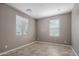 Bright living room with neutral paint, tile flooring, and natural light from two windows at 865 E Rojo Ct, Gilbert, AZ 85297