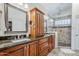 Bathroom features dual sinks, granite countertops, and a walk-in shower with custom tile accents at 1001 N Quail Ln, Gilbert, AZ 85233