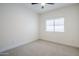 This bright bedroom has a window, ceiling fan, and neutral carpet. Recessed lighting and outlets are visible at 1001 N Quail Ln, Gilbert, AZ 85233