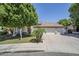 Well maintained lawn of a single story home with a three car garage at 1001 N Quail Ln, Gilbert, AZ 85233