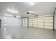 Spacious three car garage featuring epoxy floors, recessed lighting, and ample room for storage at 1001 N Quail Ln, Gilbert, AZ 85233