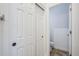 Hallway features closet and a view of a small water closet with tile flooring at 1001 N Quail Ln, Gilbert, AZ 85233