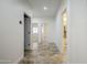 Hallway with tile flooring that leads to multiple rooms including the bathroom and office at 1001 N Quail Ln, Gilbert, AZ 85233