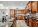 A gourmet kitchen showcases custom cabinetry, granite countertops, tile backsplash and modern stainless steel appliances at 1001 N Quail Ln, Gilbert, AZ 85233