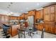 Well-appointed kitchen with a breakfast bar, wooden cabinets, stainless steel appliances, and a cozy dining area at 1001 N Quail Ln, Gilbert, AZ 85233