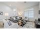 Bright living room with tile floors, large windows, and comfortable seating at 1001 N Quail Ln, Gilbert, AZ 85233