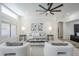 Bright living room features neutral decor, large windows, recessed lighting, a modern ceiling fan, and stylish furnishings at 1001 N Quail Ln, Gilbert, AZ 85233