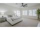 The main bedroom is bright and spacious with many windows and an exit to the pool area at 1001 N Quail Ln, Gilbert, AZ 85233