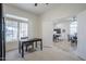 A home office is located near the main living area with neutral walls and a large window at 1001 N Quail Ln, Gilbert, AZ 85233