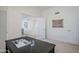 A home office with neutral colors and a large doorway overlooks the rest of the house at 1001 N Quail Ln, Gilbert, AZ 85233