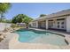 Relaxing pool features a small waterfall, a Baja shelf and is surrounded by mature landscaping at 1001 N Quail Ln, Gilbert, AZ 85233