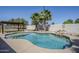 A backyard pool with water feature and shaded pergola enhance this outdoor living space at 1001 N Quail Ln, Gilbert, AZ 85233