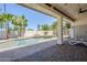 Relaxing backyard oasis featuring a private pool, waterfall feature, and covered patio area at 1001 N Quail Ln, Gilbert, AZ 85233