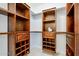 Custom walk-in closet with multiple shelving units, hanging bars, and recessed lighting at 1001 N Quail Ln, Gilbert, AZ 85233