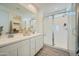 Modern bathroom with dual sinks, white cabinets, and a spacious glass-enclosed shower, offering style and functionality at 10149 E Ursula Ave, Mesa, AZ 85212