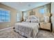 Comfortable bedroom features large windows, neutral tones, and a stylish, padded headboard for a relaxing retreat at 10149 E Ursula Ave, Mesa, AZ 85212